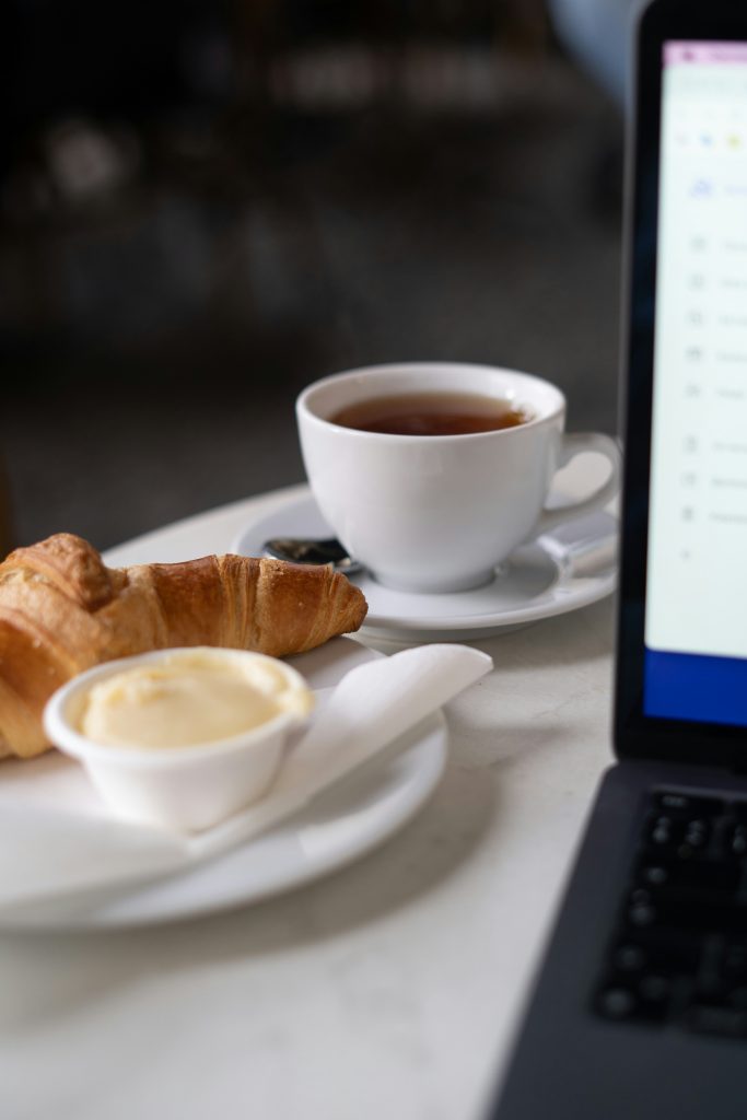 Minimal workspace with notebook and coffee in soft natural light